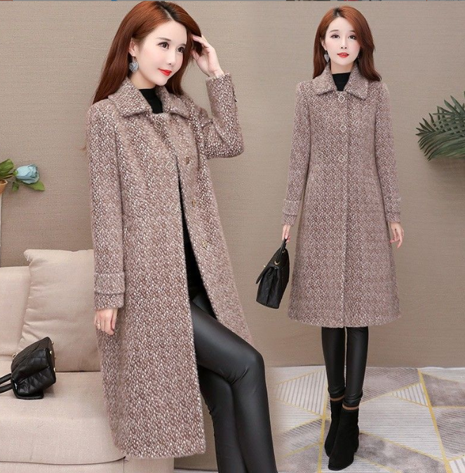 Woman wearing a long coat in a living room setting