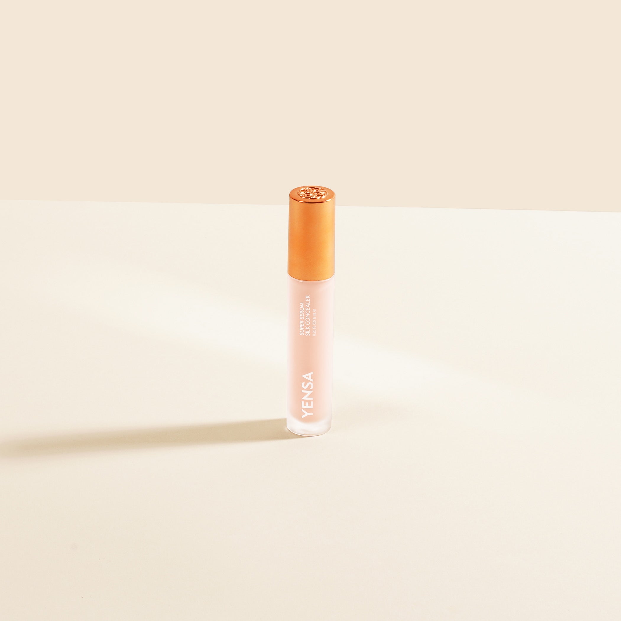 Lip balm with visible brand name on a beige background