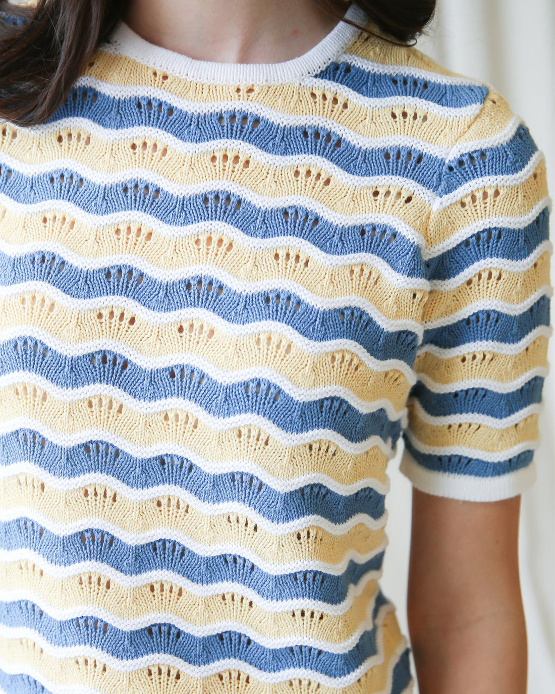 High Tides Sweater featuring a cozy knit pullover with wavy blue and yellow stripes for everyday comfort.