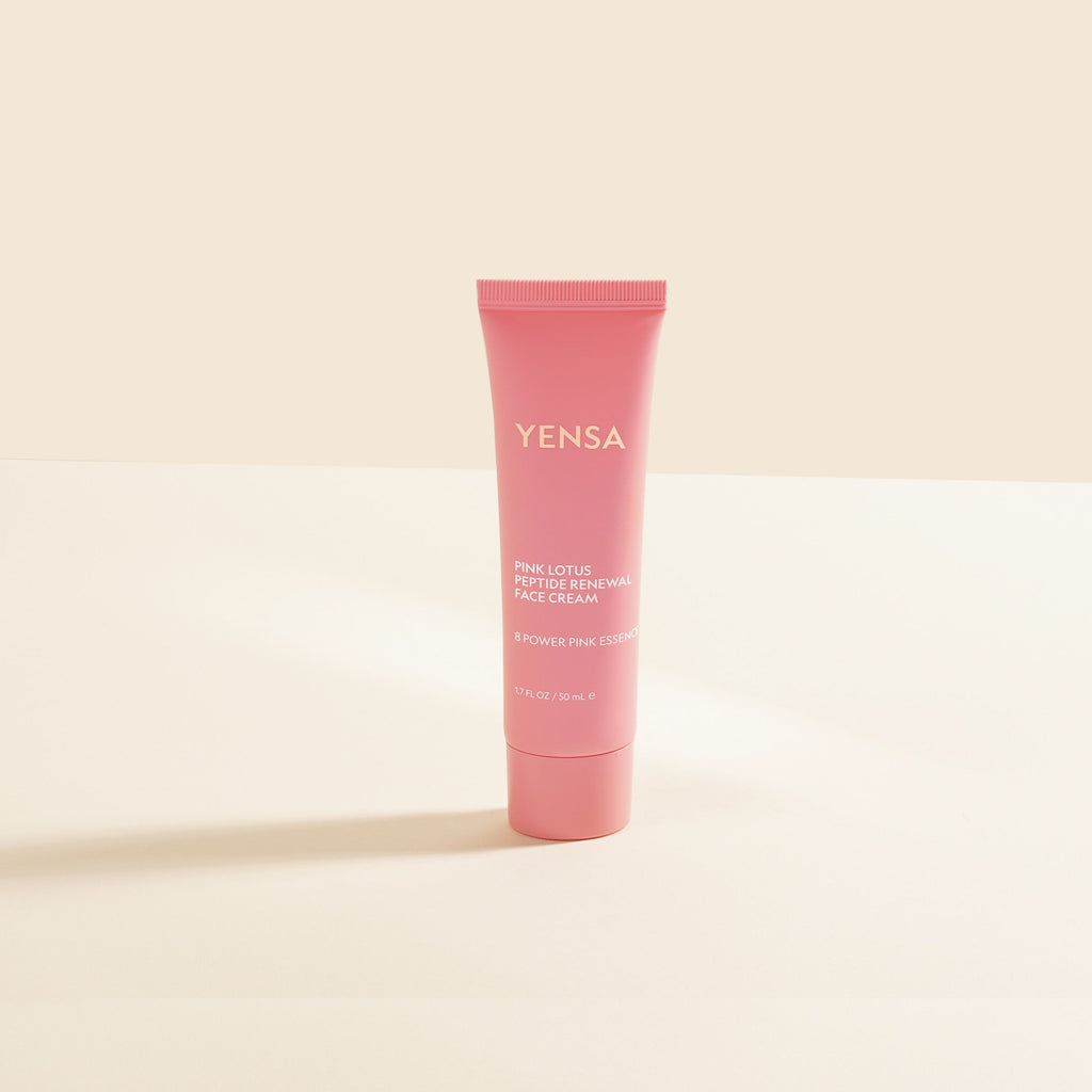 Pink tube of YENSA cream on a beige background