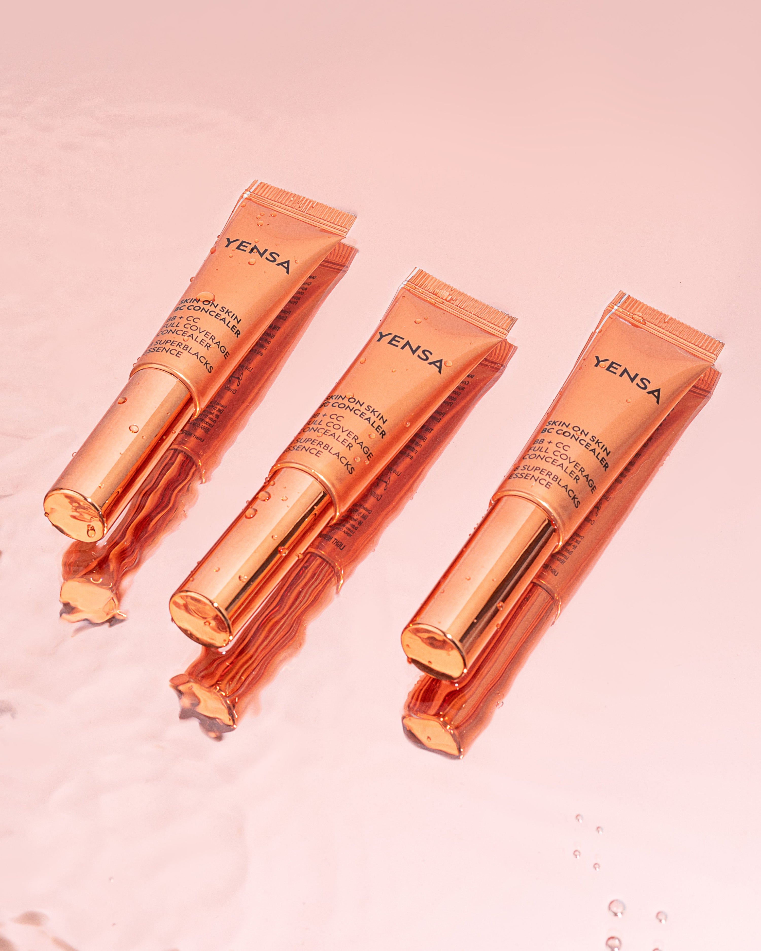 Skin On Skin BB + CC Concealer tubes floating in water highlighting full coverage serum formula.