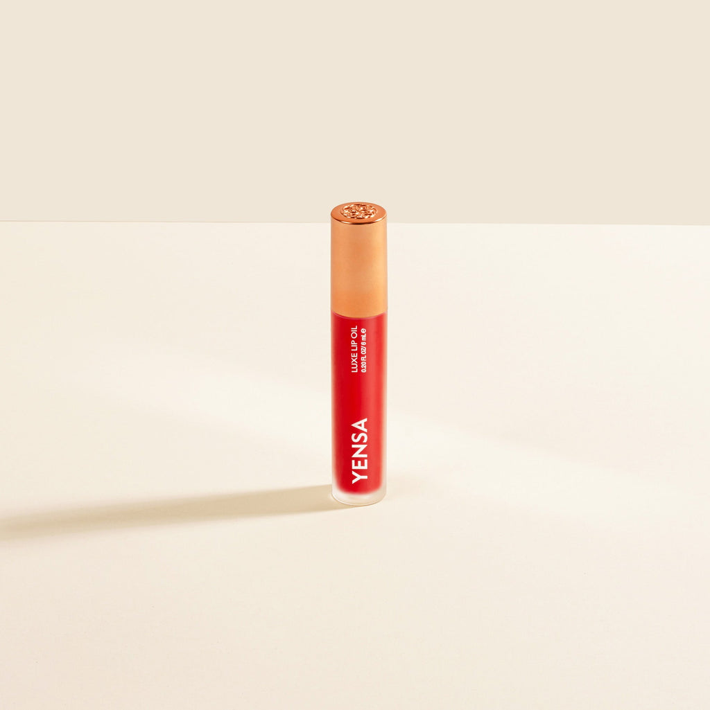 Red lipstick with 'Yensa' branding on a beige background