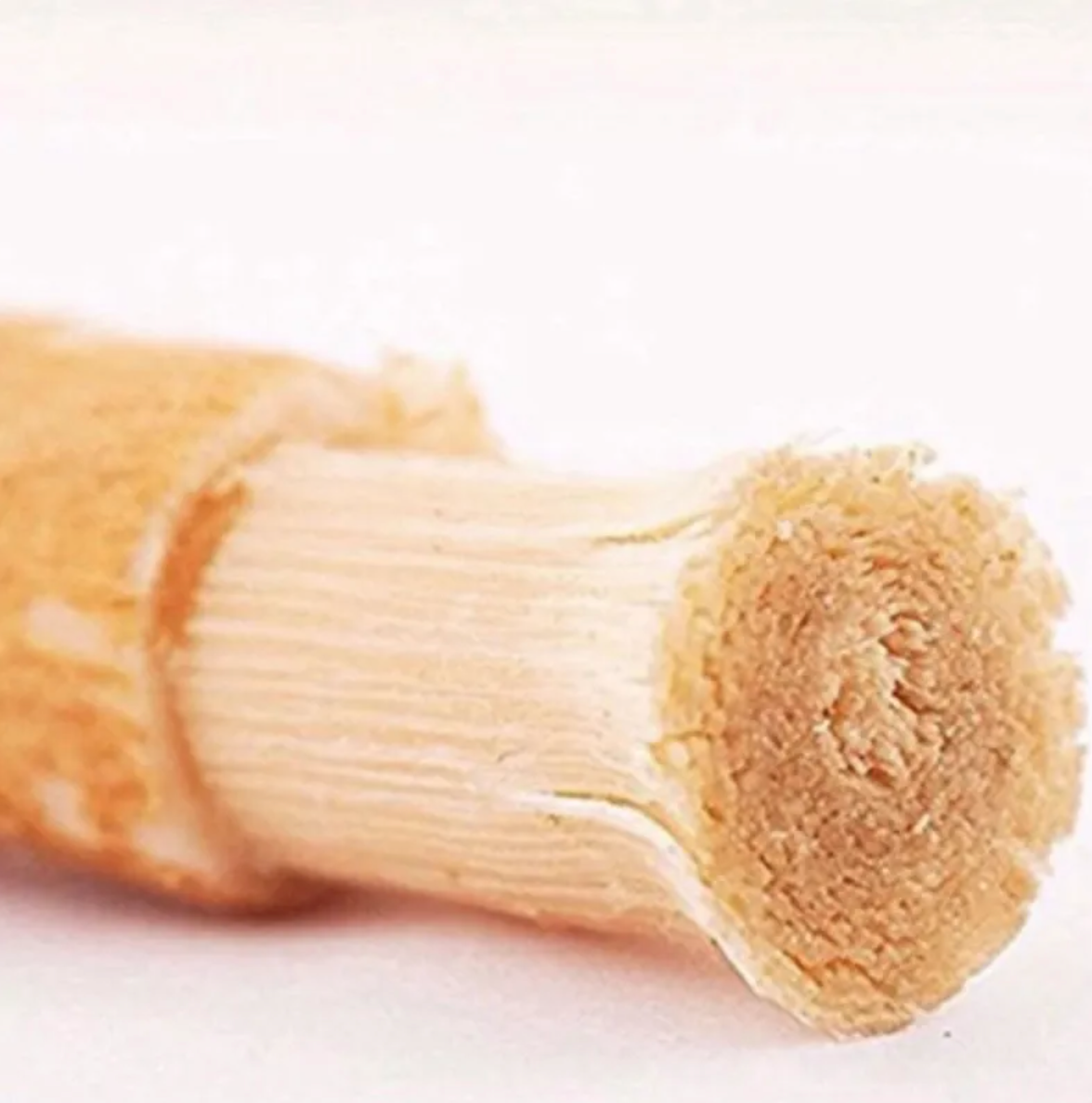 Close-up of a rolled piece of bread on a white background